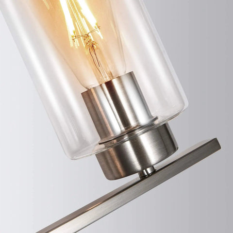 Close-up of clear glass shade and bulb on Three Light Brushed Nickel Luxe Bathroom Vanity Wall Sconce With Curved Modern Design