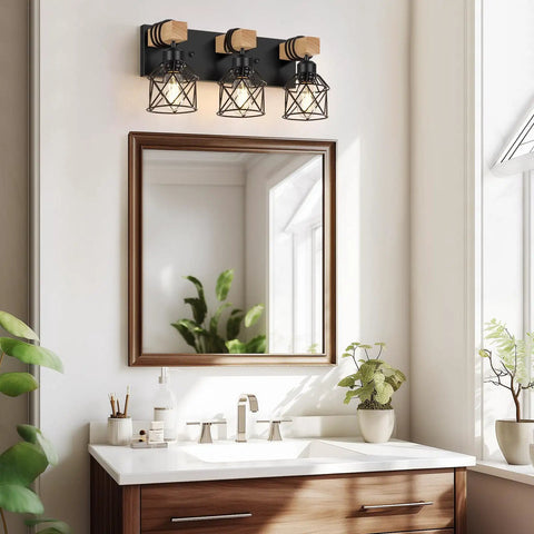3 Light Farmhouse Vanity Light above bathroom mirror, rustic wood and black metal cage, warm ambient lighting, matte black finish.