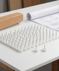 100-Pack White Nail-On Furniture Glides For Sofas And Chairs, 0.94 Inch Round Sliders with no-slip surface on a table
