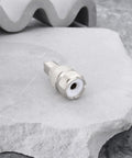 Silver UHF SO239 Female To RCA Male Coax Connector Adapter for Ham Radios on stone surface