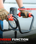 Gloved hands operating Powerful 1500W Electric Post Hole Digger Earth Auger with reverse function controls visible.