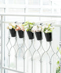 5 Pack 4 Inch Hanging Flower Pots Metal Dope Planters For Railing Fence Balcony And Garden Outdoor Decor With Detachable Hooks Ideal For Herb And Flower Gardens In Black displayed on a white fence.