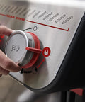 Hand adjusting dials on E-325 Propane Gas Grill With 3 Burners And 2 Boost Burners, Bold Sear Zone Heat, Stainless Controls