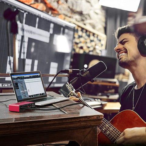 Musician recording with 2x2 USB Audio Interface With Mic Preamplifier And 48V Phantom Power For Studio Quality Recording And 24 Bit Resolution