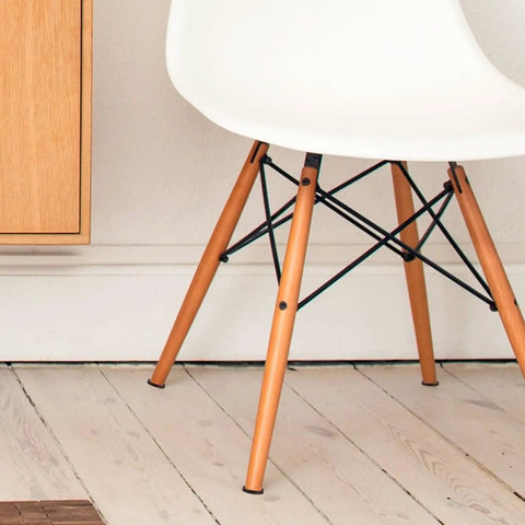 Round Rubber Furniture Coasters Non Slip Feet Pads For Tables And Chairs Easy To Install Noise Reducing Protector Cups 4 Pack Protect Floors Quiet Glide Durable Pads in use under chair legs on a wooden floor.