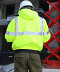 Reflective Hi Vis Bomber Jacket For Men, Waterproof Construction Safety Coat with black bottom, back view, work setting