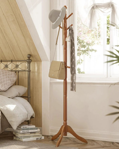 Solid Wood Coat Rack With Ten Hooks Free Standing Hall Tree in bedroom with hats and bags, caramel brown finish, stable tri leg base