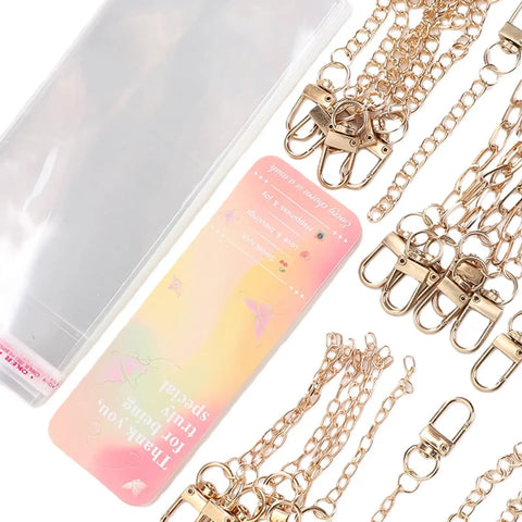 Super Sick DIY Keychain Making Kit 85 Pieces Gear With Iron Clips Cardstock Rope For Custom Charms You Gonna Love This Gift Bundle Is An Absolute Banger For Craft Lovers With Projects That Look Fire And Feel Premium Plus Bags To Keep Safe: gold clips, chains, and cardstock