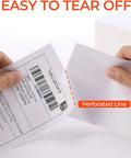 Hands tearing 4x6 thermal direct shipping labels with perforated line, pack of 500, fanfold commercial grade for easy shipping and fulfillment.