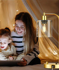 Gold Industrial Table Lamp Set With USB Port, Dope Stepless Dimmable Bedside Lamps next to family in cozy setting, clear glass shade