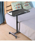Smooth Operator Height Adjusting Overbed Table Rolling Desktop Stand Up Computer Workstation next to bed with wheels.