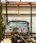 Rugged 2 Ton Telescoping Gantry Crane Portable Shop Lift Frame With Adjustable Boom Height and Locking Caster Wheels lifting a vintage truck body.
