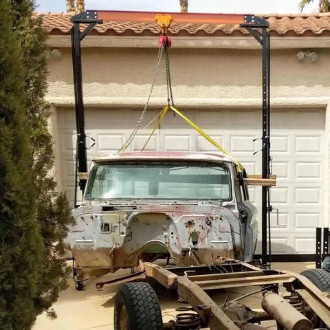 Rugged 2 Ton Telescoping Gantry Crane Portable Shop Lift Frame With Adjustable Boom Height and Locking Caster Wheels lifting a vintage truck body.