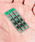 12 Pack 1S 3.7V 4A BMS Protection Board For 18650 Lithium Ion Cells showing compact circuit boards in hand.