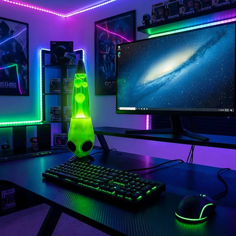 13 Inch Alien Head Wax Motion Lamp With Swirling Color Lights on a desk in a gaming setup, enhancing room ambiance