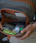 Cross Current Chest Pack for Fly Fishing Gear, open showing compartments with gear inside, durable 210D nylon, water-ready.