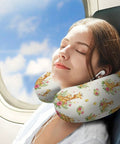 Woman using Women's Memory Foam U Shaped Neck Pillow For Travel And Daily Use Portable Lightweight Comfy for naps on plane, giraffe pattern.