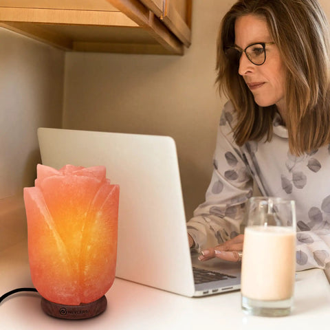 Flower Shape Pink Himalayan Salt Lamp With Wood Base And Dimmer beside laptop on desk, glowing with cozy vibes