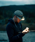 Person night fishing with Vizz Headlamp 550 Lumen Dimmable LED With IPX7 Waterproof Seal, Dual Red And White LEDs.