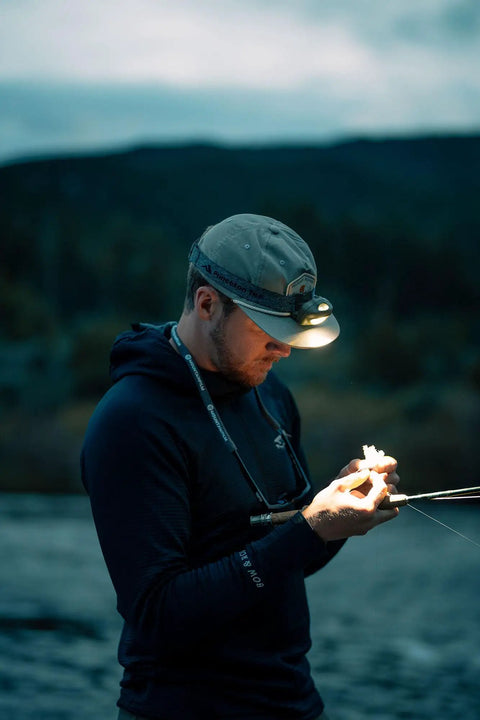 Person night fishing with Vizz Headlamp 550 Lumen Dimmable LED With IPX7 Waterproof Seal, Dual Red And White LEDs.