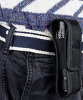 Two Pack UV Flashlight Blacklight 395nm 2 In 1 LED Tactical Flashlight And Pet Urine Detector clipped onto a belt in black holder