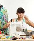 Woman sewing with machine, Easy Fix Zipper Repair Kit With 373 Pieces Including Colorful Sliders Replacement Zipper Pulls Stops visible nearby.