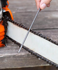 Bulk 12 Pack Chainsaw File Set With Three Sizes Five Thirty Second Inch Three Sixteenth Inch And Seven Thirty Second Inch Round Steel Files For Chainsaw Chain Sharpening And Maintenance Pro Grade Gear For Home DIY being used on chainsaw blade.