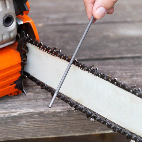 Bulk 12 Pack Chainsaw File Set With Three Sizes Five Thirty Second Inch Three Sixteenth Inch And Seven Thirty Second Inch Round Steel Files For Chainsaw Chain Sharpening And Maintenance Pro Grade Gear For Home DIY being used on chainsaw blade.