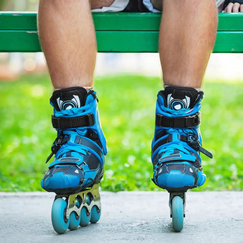 Blue inline skates with 2 Pack Inline Skate Strap Replacement Kit With Screws And Nuts For Universal Buckles, worn by person on bench