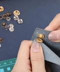 Hands using 7 Pack Leather Rivet Setter Tools Kit For Leathercraft With Die Punch Snap Fasteners, applying rivet on blue fabric.