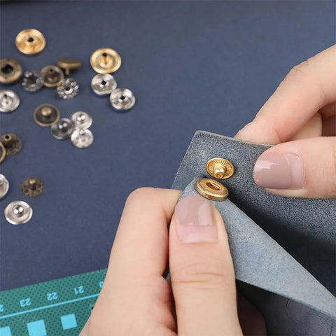 Hands using 7 Pack Leather Rivet Setter Tools Kit For Leathercraft With Die Punch Snap Fasteners, applying rivet on blue fabric.