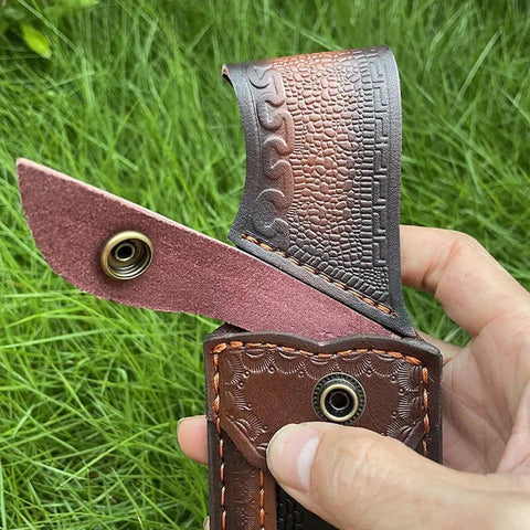 Close-up of rugged leather knife sheath for fixed blade with secure buckle and intricate stitching design.
