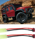 Four Pack Mini Tamiya To T Plug Adapter Cable 13cm 16AWG Silicone Wire For RC Battery Charging next to red RC car on rocky terrain
