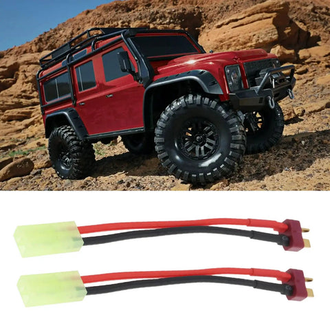 Four Pack Mini Tamiya To T Plug Adapter Cable 13cm 16AWG Silicone Wire For RC Battery Charging next to red RC car on rocky terrain