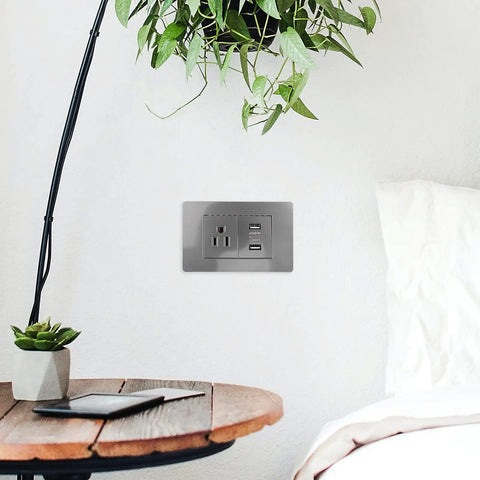 15 Amp Us Standard Wall Outlet With Dual Usb Charging Ports, Built Tough Pp Housing With Genuinely Solid Bronze Contacts, No-Hassle Hookup For Desk Lamps And Bedside Tables, Secure Screw Mount Receptacle in grey installed beside a bed.