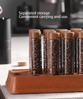 Keep Your Daily Coffee Run Fresh With This Top Tier Airtight Single Dose Bean Cellar Crafted From Genuine Walnut Wood And Clear Glass Tubes Designed To Be Hella Dope On Any Modern Counter While Blocking Out That Stale Funky Taste - walnut wood jar with clear tubes holding coffee beans.