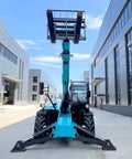 Heavy Duty Telescopic Forklift With Fast Swap Quick Hitch Setup For Effortless Pallet Handling On Rough Ground facing camera in industrial area.