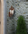 Oxford Style 1 Light Imperial Bronze Cast Aluminum Wall Lantern with Amber Water Glass on brick wall outdoors