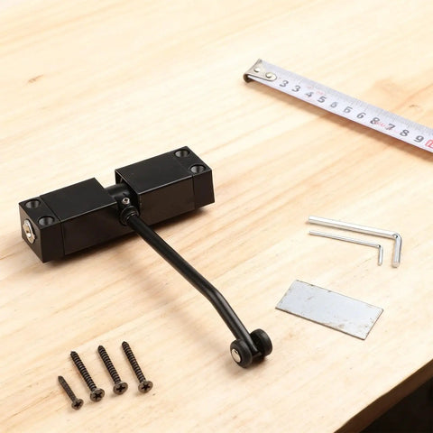 Automatic Hydraulic Door Closer With Stainless Steel Spring Hinge, Black Finish, with screws and tools on wooden surface.