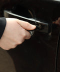 Person unlocking car door using a key, illustrating usage of Graphite Powder Enhanced Lock Lubricant Stick LE4 Lock Ease 3.4 Oz