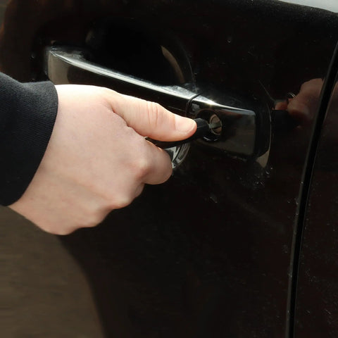 Person unlocking car door using a key, illustrating usage of Graphite Powder Enhanced Lock Lubricant Stick LE4 Lock Ease 3.4 Oz
