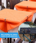 12 Pack Tablecloth Clips for Folding Tables and Outdoor Use securing orange tablecloths outdoors.