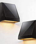 Tailgate Ready Solar Wall Lights Outdoor 2 Pack Rain Resistant Sconces mounted on wall, showing solar panels and warm light.