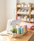 Heavy Duty Thread Spool Stand For Sewing Machines Featuring A Sick Anti Tangle Guide And Jumbo Cone Holder Totally No Sweat Bracket For Quilting Embroidery Setup Straight Up Smooth Operation In White next to sewing machine with colorful thread.
