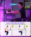 Person using 33.5 Inch Compact Gamer Desk With Remote RGB LED Lights And 3 In One Power Hub Monitor Stand CPU Stand Built In Storage Drawer And Side Hooks Space Saving Gaming Table For Home Office Or Bedroom Black.