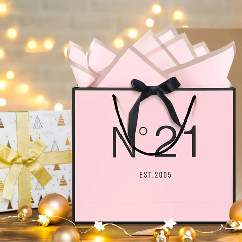 13 Inch Birthday Gift Bag Set with Card Envelope Ribbon Bow and Tissue Paper for Women and Girls Handles includes Greeting Card Milestones from 13th to 100th, pink themed with black handles and bow, festive background.