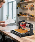 Front view of Twotrees TTC3018 Pro desktop CNC router with black frame and red spindle engraving wood.