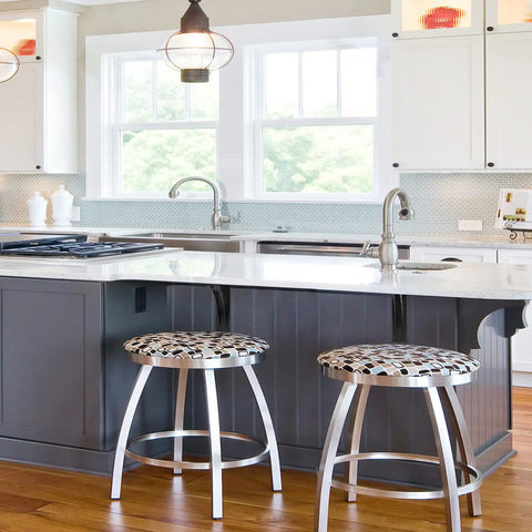 Modern kitchen with island and chrome bar stools under pendant lighting, hardwood floor, and large windows