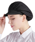 Top Shelf Three Pack Chef Hats For Women And Men With Brimmed Elastic Fit Breathable Poly Cotton Kitchen Cooking Caps For Restaurant Shifts And Weekend Cookouts, black cap worn by woman in profile.