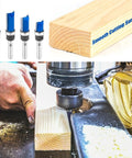 Four Piece Set Of Tough As Nails Tungsten Carbide Flush Trim Router Bits With 1/4 Inch Guided Shank For Slick Woodworking Cuts Perfect For Millwork Shop on a woodworking surface.